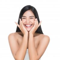 Portrait of Beautiful Skin care woman enjoy and happy,touching her face,isolated with clipping path.
